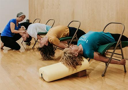 yoga instructor with student stretching