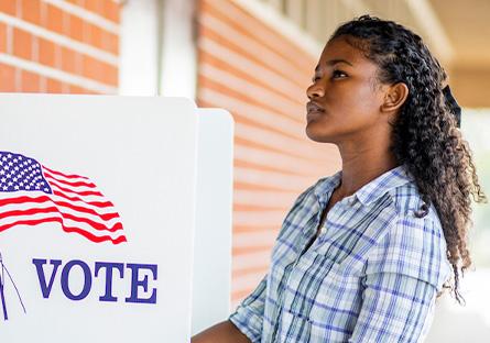 student at voter registration booth