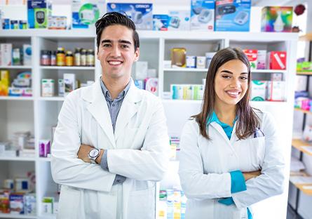 pharmacy technicians working behind the counter in a pharmacy