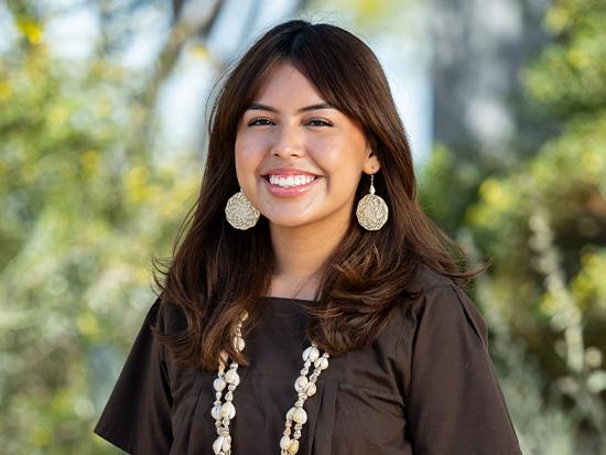 Smiling student wearing Native American attire.