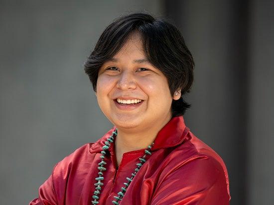 Smiling student wearing Native American attire.