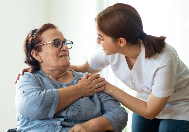 A young woman helping an elderly woman