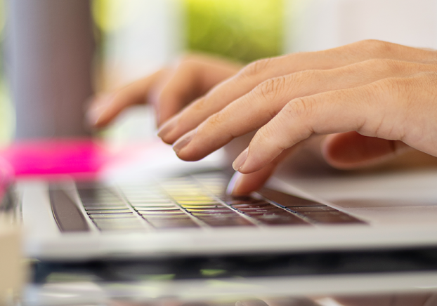 hands typing on laptop