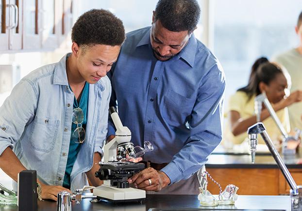 student and teacher working in lab